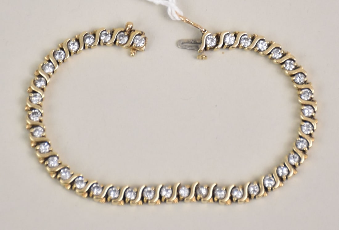 14K Yellow Gold Diamond Tennis Bracelet. 39 diamonds 1/8 each SI1 G-H approx. 5 carats total. 7" in: 14K Yellow Gold Diamond Tennis Bracelet. 39 diamonds 1/8 each SI1 G-H approx. 5 carats total. 7" in length. Wt. 18.4 grams