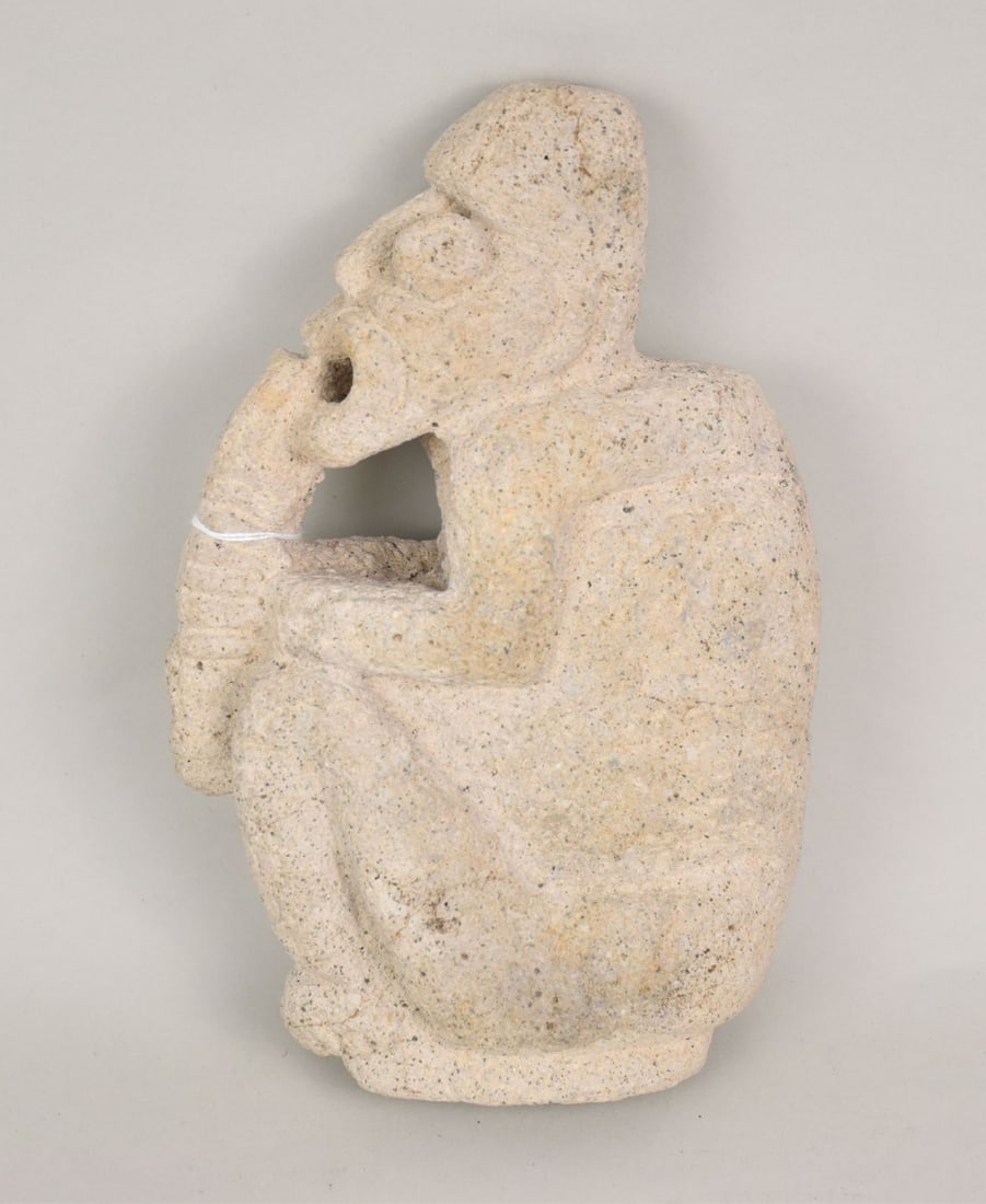 Pre-Columbian Peru Chavin Style Stone Figure - A carved stone figure depicting a man playing a flute (1 of 4)