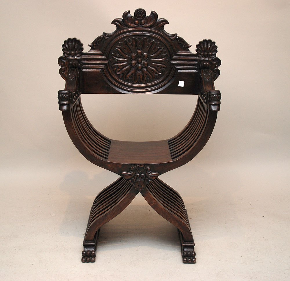 Spanish colonial arm chair with curule frame, heav: Spanish colonial arm chair with curule frame, heavily carved, 42"h