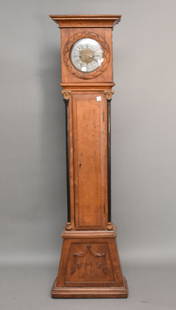 French mid 18th century walnut tall case clock with shaped crest over conforming glass door opening: French mid 18th century walnut tall case clock with shaped crest over conforming glass door opening to circular enameled face with roman numerals and pieced brass framing; the body with single tapered