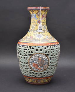 A Reticulated Famille Rose Porcelain Rotating Vase, Qianlong Mark - A Chinese Famille Rose enameled: A Reticulated Famille Rose Porcelain Rotating Vase, Qianlong Mark - A Chinese Famille Rose enameled "Zhuanxinping" Rotating Vase. The light blue glazed revolving body reticulated with four evenly spac