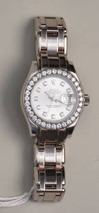 Ladies 18K White Gold 1995 Rolex Oyster Perpetual date just Diamond Bezel.  29 jewel movement and: Ladies 18K White Gold 1995 Rolex Oyster Perpetual date just Diamond Bezel. 29 jewel movement and synthetic sapphire crystal 10 paved brilliant diamonds on dial and 32 F-G SI1 .07 diamonds bezel serial