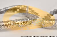 Angela Cummings 18K Yellow Gold Snakeskin Diamond Bangle Bracelet. The piece secures with a push in