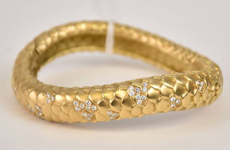 Angela Cummings 18K Yellow Gold Snakeskin Diamond Bangle Bracelet. The piece secures with a push in: Angela Cummings 18K Yellow Gold Snakeskin Diamond Bangle Bracelet. The piece secures with a push in clasp and latch for additional security. 6-3/4” inner approx 1/2" wide circumference 18K yello