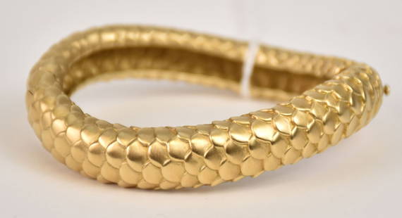 Angela Cummings 18K Yellow Gold Snakeskin Bangle Bracelet. The piece secures with a push in clasp: Angela Cummings 18K Yellow Gold Snakeskin Bangle Bracelet. The piece secures with a push in clasp and latch for additional security. 6-3/4” inner circumference approx 1/2" wide 18K yellow gold A