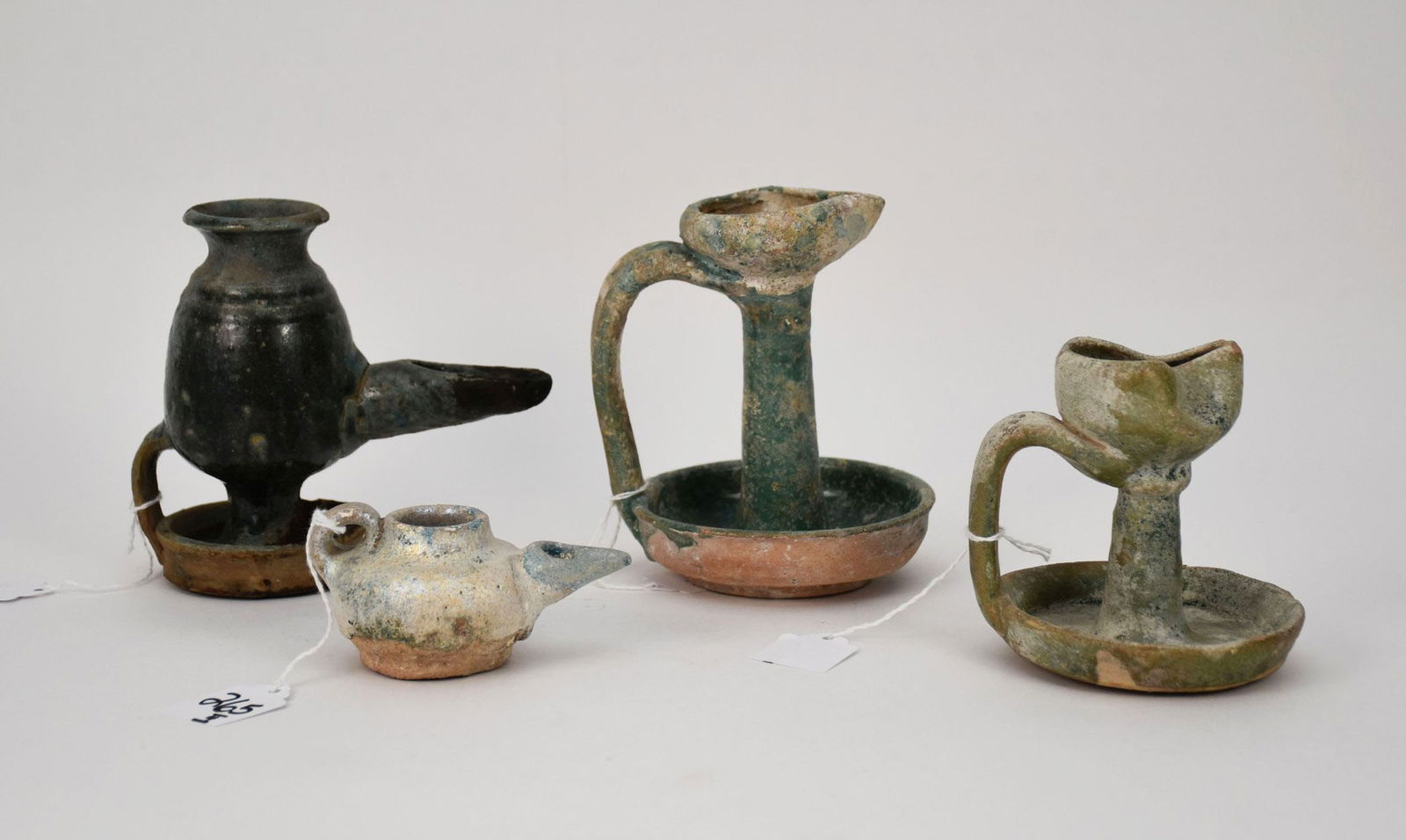 Four Early Persian Glazed Pottery Oil Lamps, c. 12th-13th Century AD. Iran, Rhages area or Nishapur. (1 of 8)