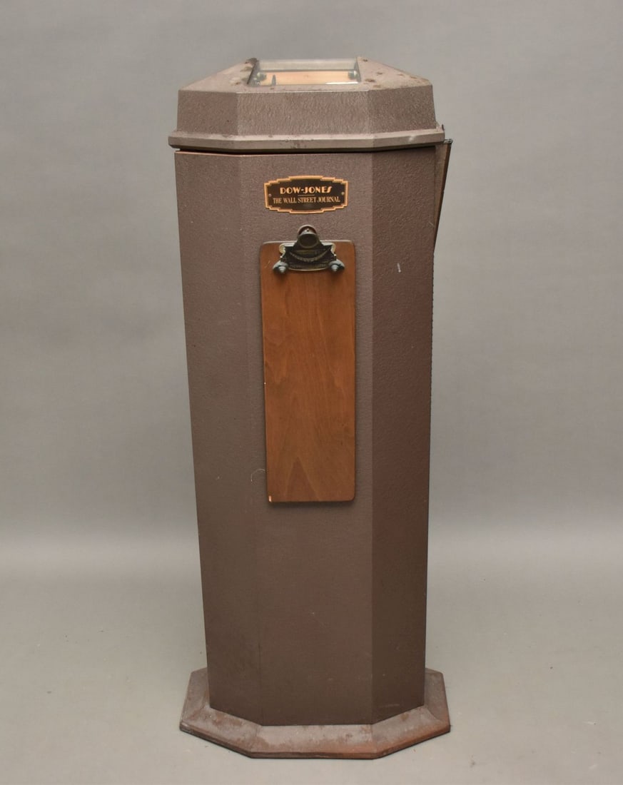 Metal Standing Piece of Memorabilia, Dow Jones Wall Street Journal Plaque & Clip Board Attached to: Dow Jones stocker ticker tape machine Primarily used in the 1950s-1960s, the Dow Jones stocker ticker tape machine was eventually replaced by the invention of the computer. These machines were were kn