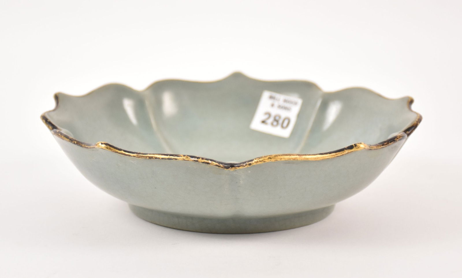 Chinese Celadon Crackle Glazed Lotus Bowl - A porcelain bowl with a celadon crackle glaze, scalloped: Chinese Celadon Crackle Glazed Lotus Bowl - A porcelain bowl with a celadon crackle glaze, scalloped "lotus" petal formed rim and walls, capped with a patinated gilt metal rim edge. The underside of f