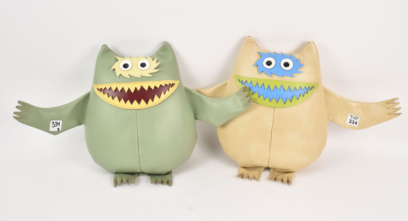Two Vintage Nauga Monsters - Naugahyde fabric. One monster light green, the other tan. 13 - 14" h.: Two Vintage Nauga Monsters - Naugahyde fabric. One monster light green, the other tan. 13 - 14" h. Condition: Minor normal wear.
