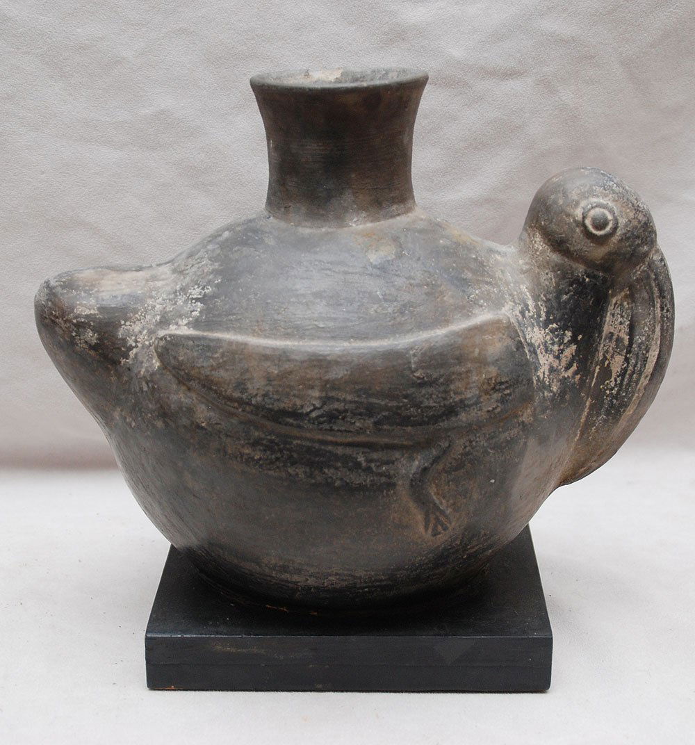 Mythological Pre-Columbian bird on attached wooden: Mythological Pre-Columbian bird on attached wooden stand, This is a Pre-Columbian Antique, pelican is a Chimu piece (Refer to "Ancient Arts and the Andes" by Wendell C. Bennet published by Museum of M