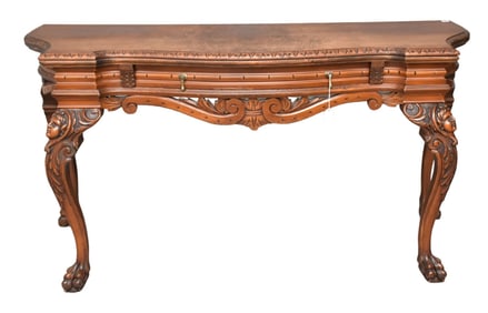 Burled and figured mahogany table, shaped top above carved single drawer over carved front legs with