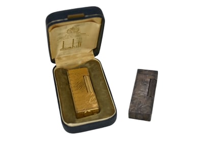 2 Dunhill Lighters. Gold and silver tone and 1 original box.