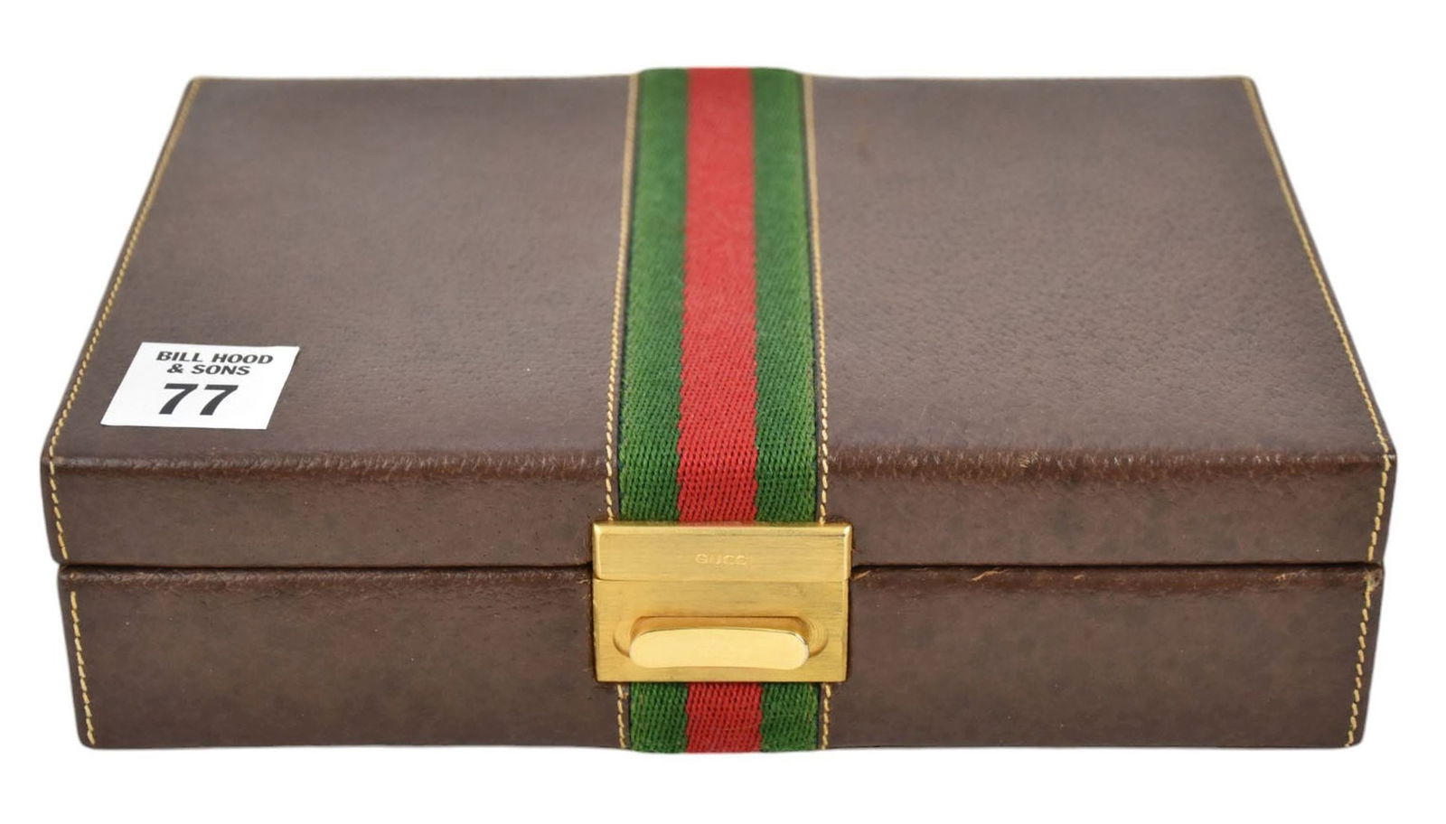 LOT IN VINTAGE GUCCI BOX, TWO STERLING SILVER GUCCI: LOT IN VINTAGE GUCCI BOX, TWO STERLING SILVER GUCCI ACCESSORIES a) one Gucci enameled money clip. b) one initial A pendant Both Stamped Gucci 925 Italy, these weigh 30.4dwt. Total + c) one gold filled