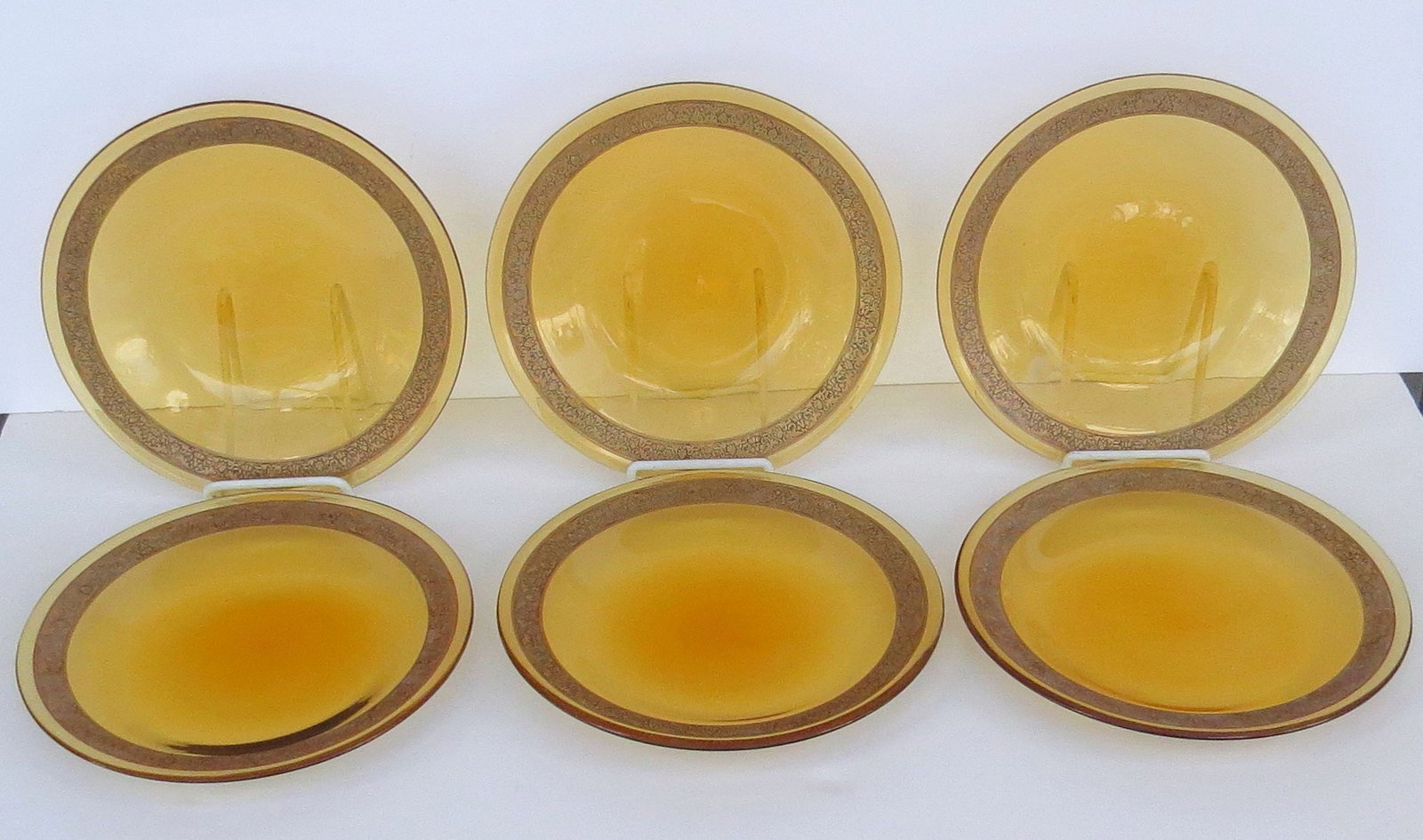 Set of 12 MOSER Blown Amber Lead Crystal Plates with Etched Gilt OROPLASTIC decorative bands near: Set of 12 MOSER Blown Amber Lead Crystal Plates with Etched Gilt OROPLASTIC decorative bands near the rims; each 9 ¾ inches diameter. The etched gilt technique was introduced in 1915. Condition