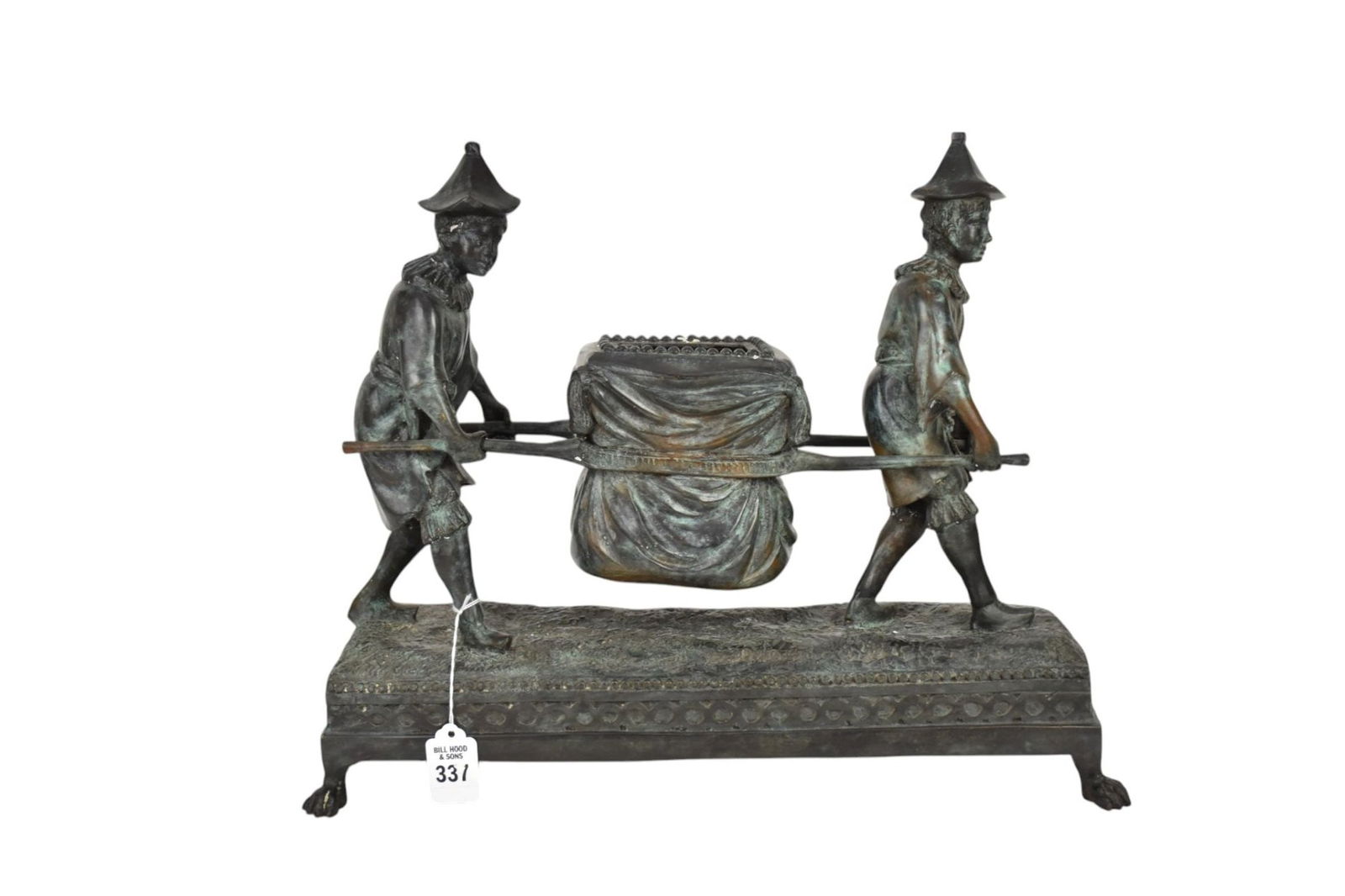 Maitland-Smith Bronze Centerpiece of Two Boys with a Litter - Depicting two youths carrying a litter: Maitland-Smith Bronze Centerpiece of Two Boys with a Litter - Depicting two youths carrying a litter transport, dressed in tunics with ruffled collars, short ruffle bottom pants and conical hats. Upon