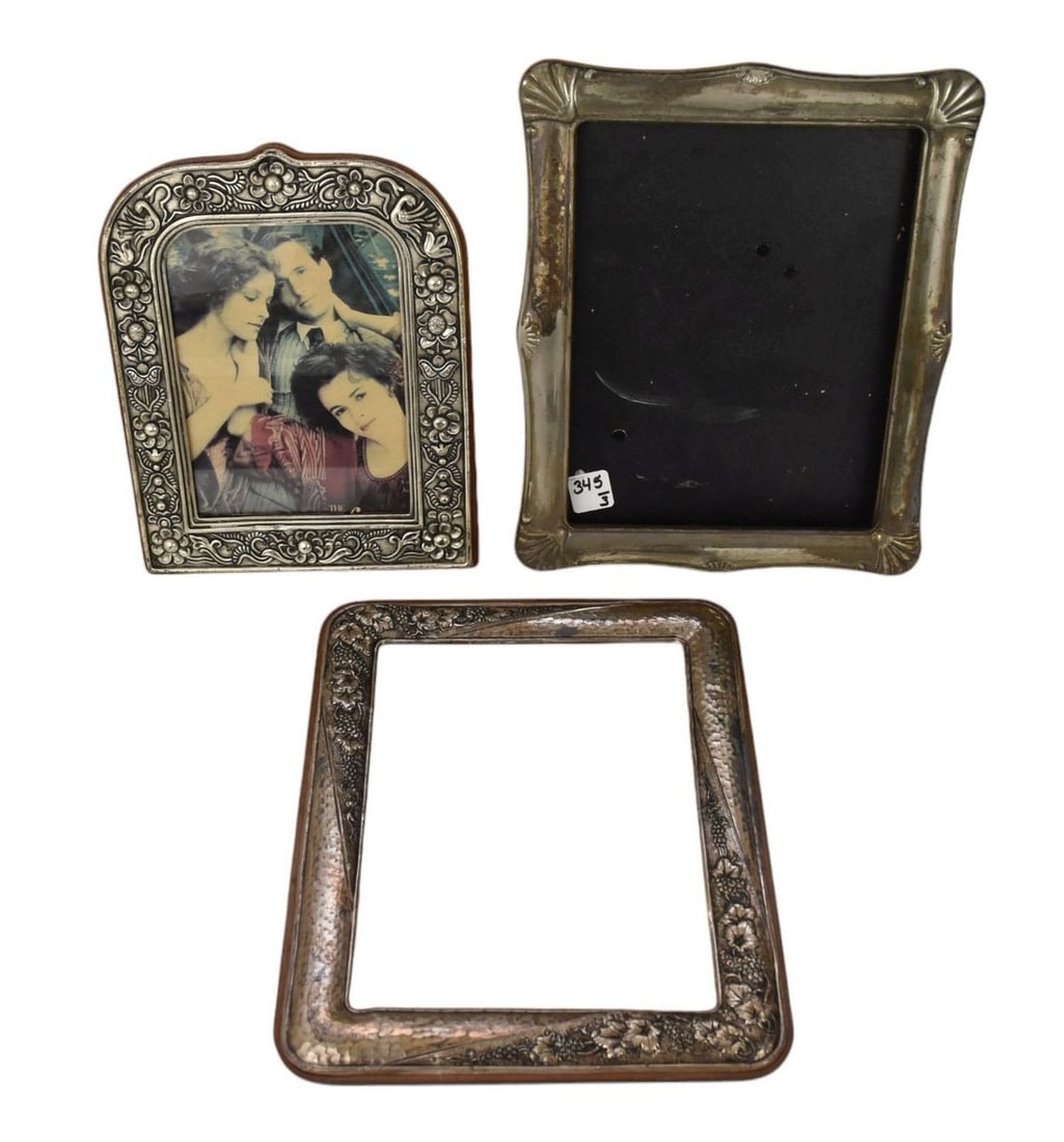 Three Picture Frames, Two Sterling, One Silverplate - Comprising: A rectangular silver frame, marked: Three Picture Frames, Two Sterling, One Silverplate - Comprising: A rectangular silver frame, marked 950 silver, grapes and vine motif, 12 1/8" h x 9 3/4", missing back. An arched frame, marked 925 st