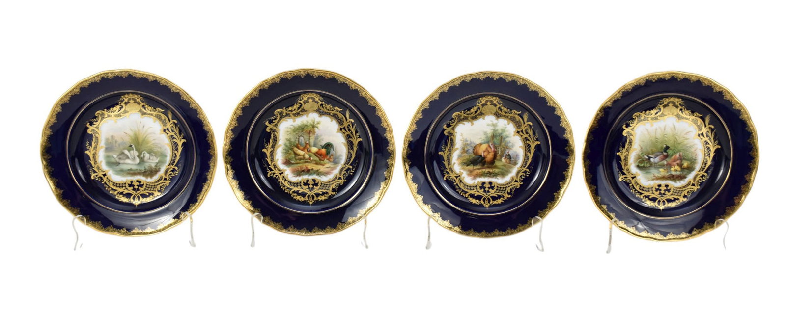 Four Meissen Cobalt-Blue Ground Cabinet Plates, C. Late 19th Century - Each center finely painted: Four Meissen Cobalt-Blue Ground Cabinet Plates, C. Late 19th Century - Each center finely painted with domestic fowl in rural landscapes, or ducks and swans swimming beside lakeside grasses, each with