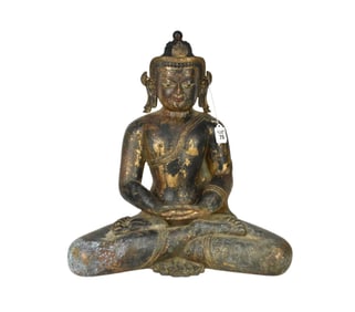 A Seated Bronze Tibetan Shakyamuni Buddha - A patinated bronze seated Buddha figure with traces of