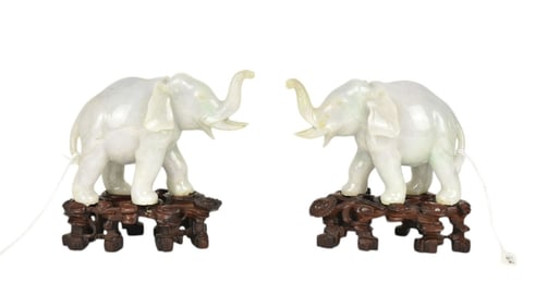 Pair Chinese Carved Jade Elephant Figures - A pair of carved elephants, depicted with trunks up.