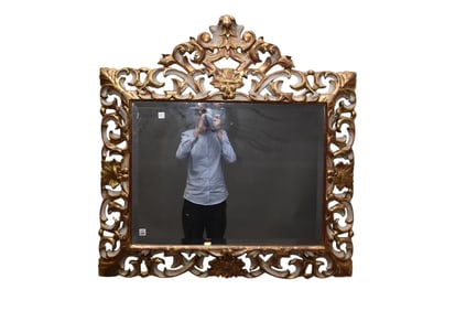 Italian Rococo Style Giltwood Patinated Mirror, Mid-19th Century, Having a beveled glass mirror