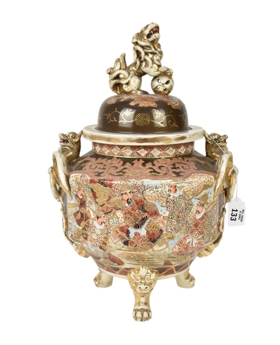 Satsuma Footed Jar with Winged Dragon Handles, C. 1900 - A Satsuma pottery jar upon tripod feet,: Satsuma Footed Jar with Winged Dragon Handles, C. 1900 - A Satsuma pottery jar upon tripod feet, covered with a foo dog finial, flanked by winged dragons. No apparent marks. 16 1/2" h x 11 1/2" w. Con
