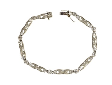 Art Deco Platinum Diamond Bracelet. Length 7" wt. 18 grams. 8 .10 mine cut diamonds and 16 .05 mine