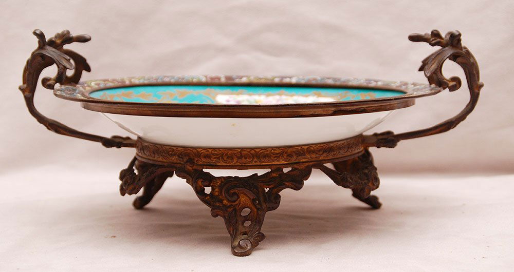 Sevres shallow dish with lady and putti at center, cham: Sevres shallow dish with lady and putti at center, champleve fitted frame on 3 scroll feet, 5 1/8"h x