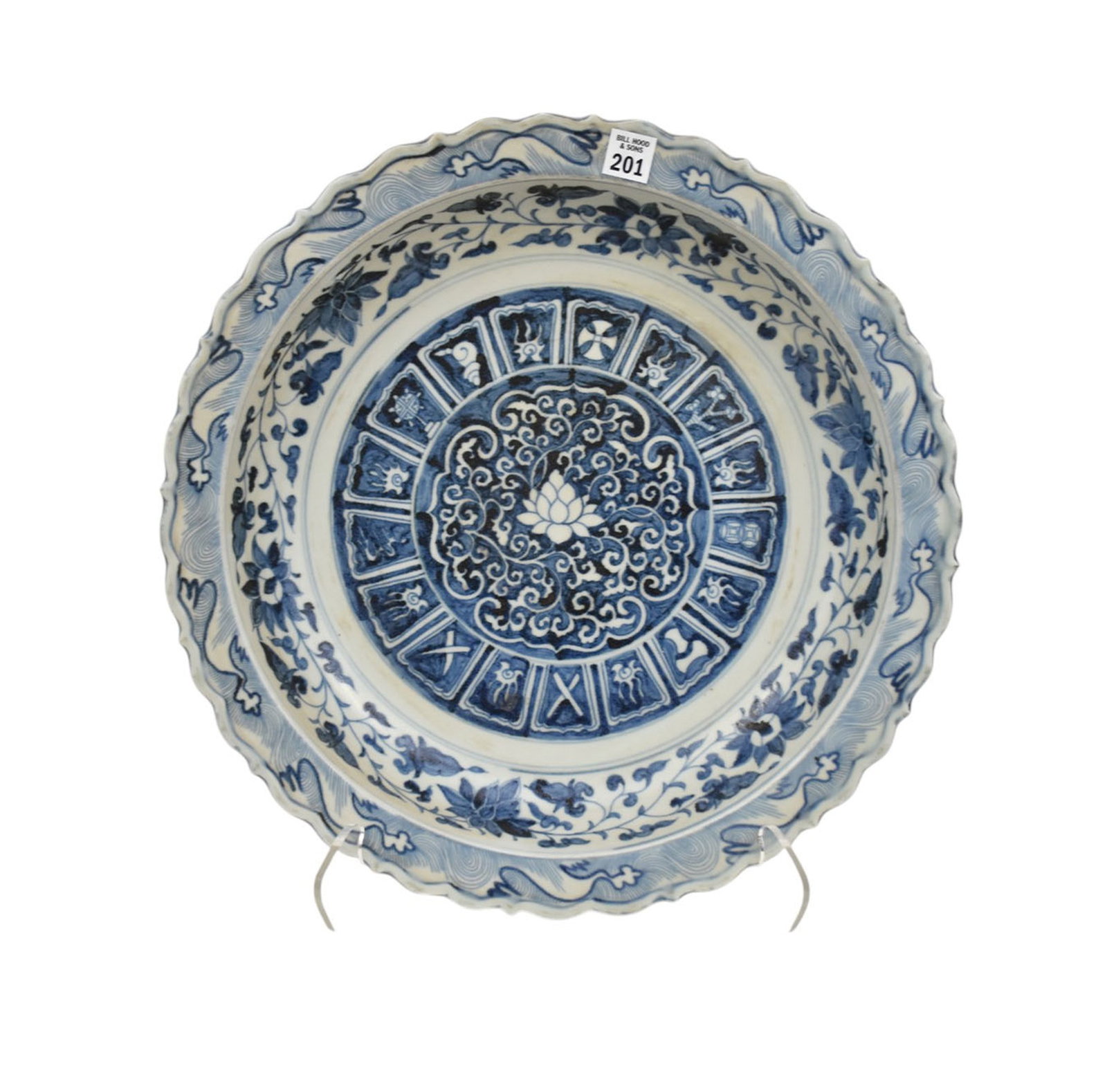 Chinese Blue & White Porcelain Charger - A large Chinese porcelain bowl with a scalloped rim. Blue: Chinese Blue & White Porcelain Charger - A large Chinese porcelain bowl with a scalloped rim. Blue underglaze decoration featuring auspicious symbols, foliate scrolls, waves and lotus flowers. Two pap