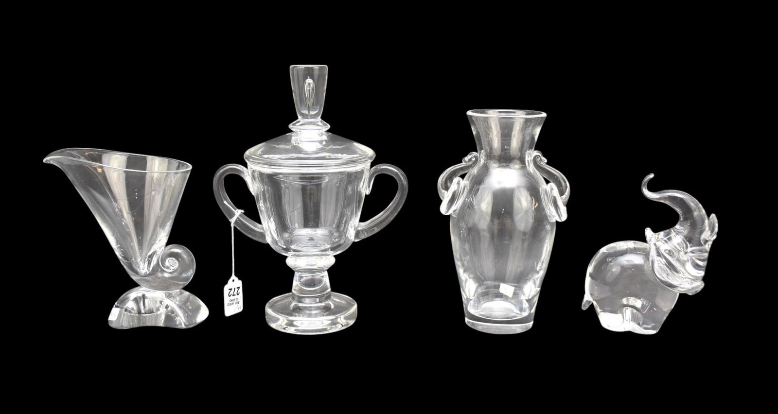 4 Steuben Tableware's, Covered Compote On Pedestal, 11"h x 9"w Vase Double Ring Handles, 9"h x 6"w,: 4 Steuben Tableware's, Covered Compote On Pedestal, 11"h x 9"w Vase Double Ring Handles, 9"h x 6"w, Vase with Snail on Rock Motif, 7 1/2"h x 6 1/2"w and Elephant, 6 1/2"h x 6"w All are in Good conditi