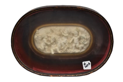 Antique Carved 3d relief plaque of cherubs and animals in leather wrapped frame (the glass is a bit