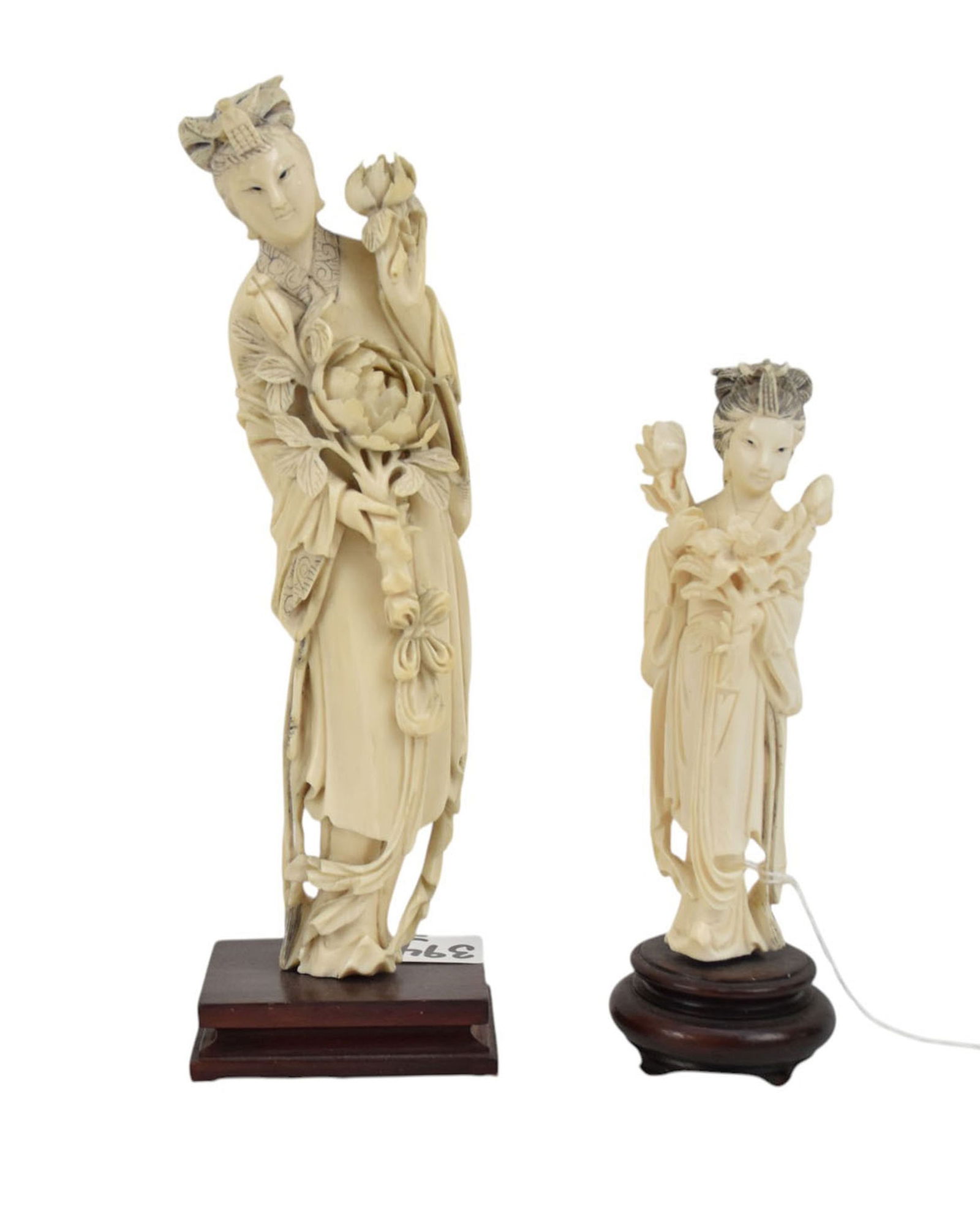 Two Chinese Carved Figures of Guanyin - Two Chinese carved bone figures of a female holding flowers.: Two Chinese Carved Figures of Guanyin - Two Chinese carved bone figures of a female holding flowers. Each on wood bases. Small - 5 1/4" h, 1" h base; Larger - 7 3/4" h, 3/4" base