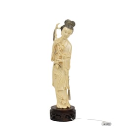 Chinese Carved Figure of Guanyin - A carved female figure of Guanyin, standing and holding flowers.