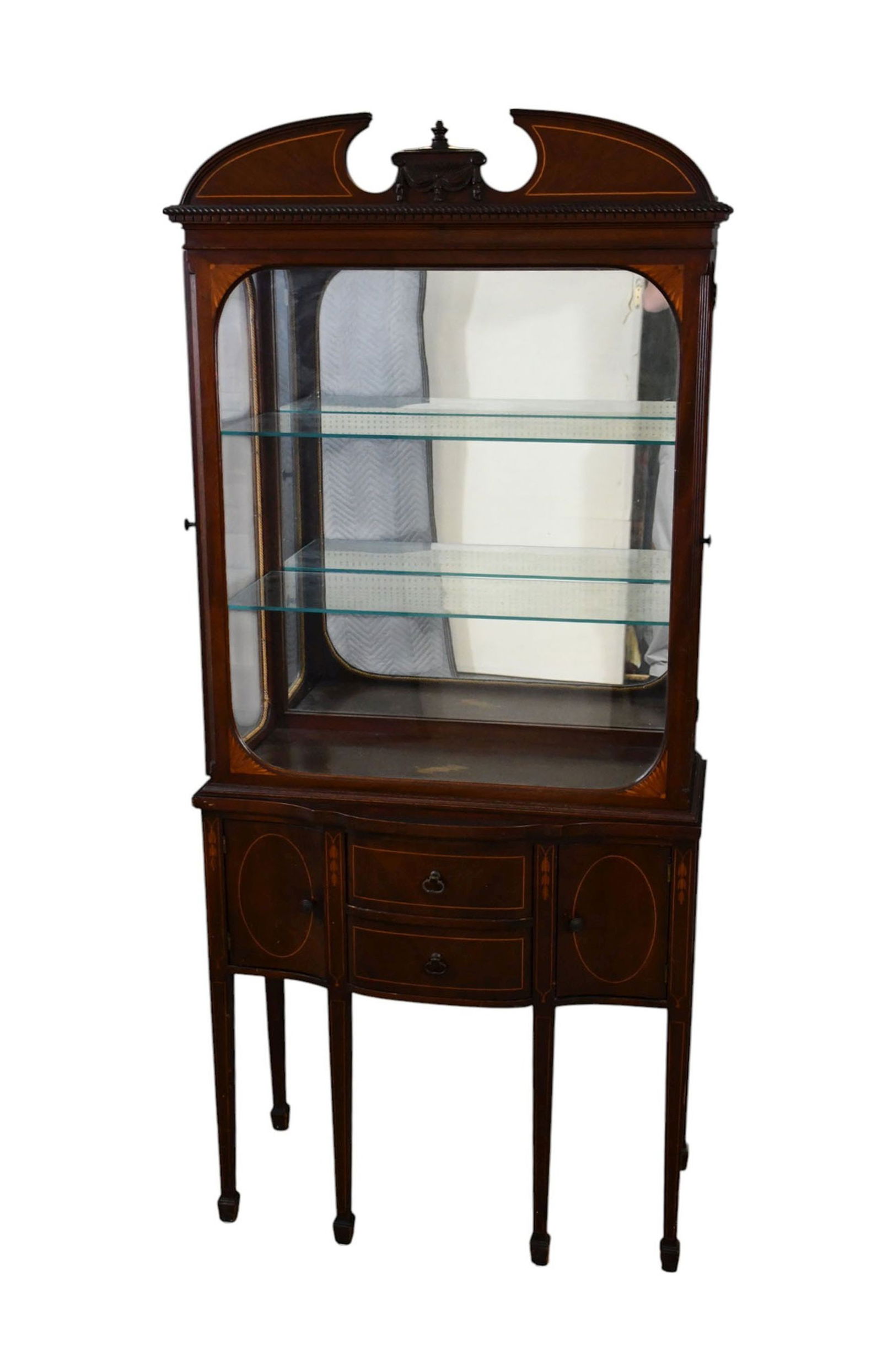 Diminutive Mahogany Vitrine, Circa 1900, Urn & Drape Over Glass Front, Sitting on 2 Drawers Flanked: Diminutive Mahogany Vitrine, Circa 1900, Urn & Drape Over Glass Front, Sitting on 2 Drawers Flanked by Cabinet Doors Raised on Legs with Spade Feet, 66"H x 29"w ***If this item is not picked up by the