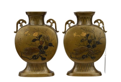 A pair of footed vases with flowers and vines and gilt highlights. No apparent signature, H. 6