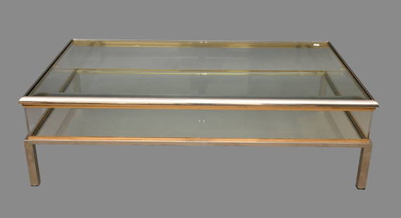 Modern Chrome Glass & Brass Coffee Table and Display Piece, 15"h x 50"w x: Modern Chrome Glass & Brass Coffee Table and Display Piece, 15"h x 50"w x 29"d ***If this item is not picked up by the Friday following the auction, it will be moved to offsite storage and pickup will