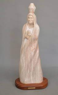 NATIVE AMERICAN ALABASTER SCULPTURE “TAOS MAIDEN?? BY TAVA - White with pink variegated alabaster: NATIVE AMERICAN ALABASTER SCULPTURE “TAOS MAIDEN&rdquo; BY TAVA - White with pink variegated alabaster sculpture of woman on wooden base with name plate plaque Signed Tava and dated “91&rdquo;. Di