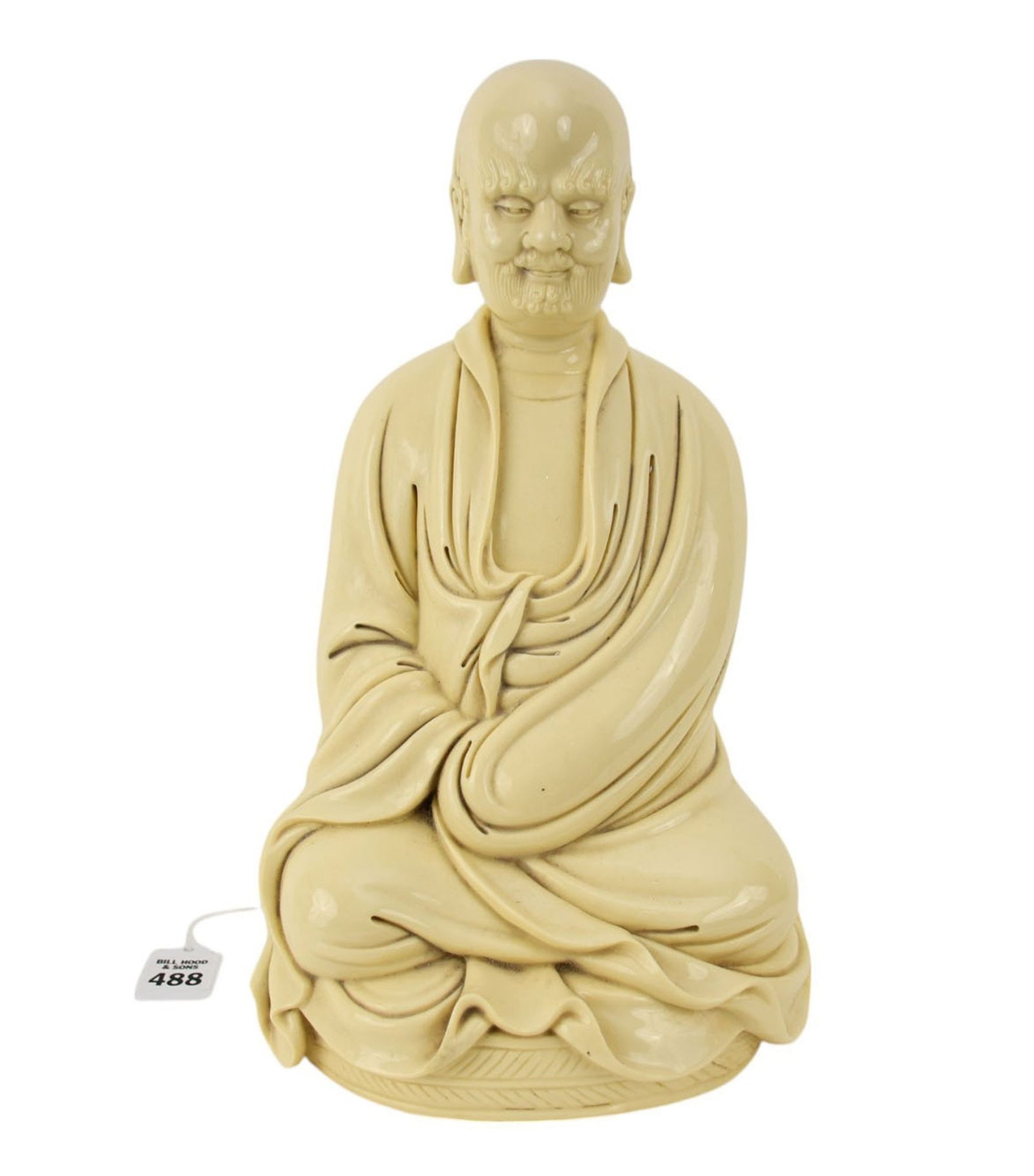 Chinese Porcelain Buddhist Figure of Bodhidharma - A cream glazed porcelain figure of a seated: Chinese Porcelain Buddhist Figure of Bodhidharma - A cream glazed porcelain figure of a seated Buddhist monk. Depicting the robed Chinese patriarch, Bodhidharma, seated in meditative pose. The back of