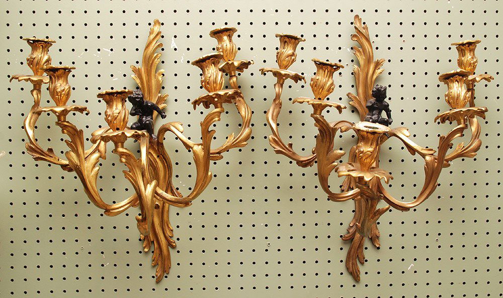 Pair of gilt bronze 5 light rococo wall sconces with bl: Pair of gilt bronze 5 light rococo wall sconces with black putti, 19 1/2"h x 16 1/2"w (damage)