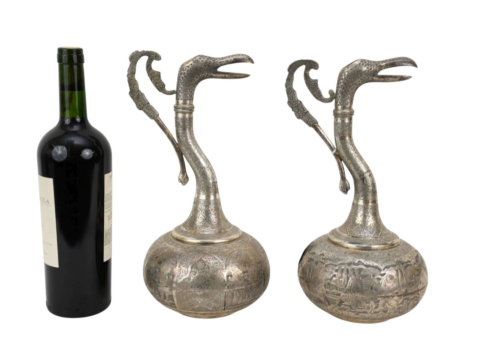 Pair of Persian Silver Bird-Form Jugs, C. Early 20th Century - Long zoomorphic neck ending in the: Pair of Persian Silver Bird-Form Jugs, C. Early 20th Century - Long zoomorphic neck ending in the head of an open-mouthed bird, stylized handle, globular body with engraved banquet scenes and ornate P