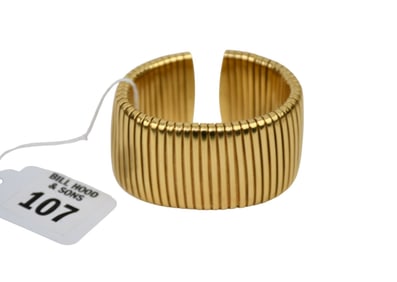 18K Yellow Gold Flex Band. Roman 750, width 1.25" inner circumference 5" with 1" - 2" opening. Wt.