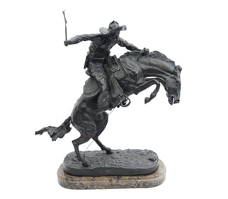 Frederic Remington "Bronco Buster" Bronze Sculpture. Features a cowboy riding a top a wild rearing