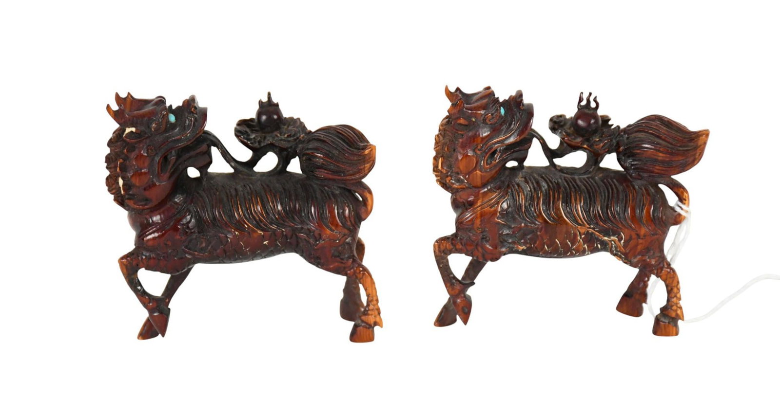 A Pair of Chinese Carved Qilin Figurines - Two antique carved and painted bone figures depicting a: A Pair of Chinese Carved Qilin Figurines - Two antique carved and painted bone figures depicting a Qilin/Kirin, the mythological dragon horse. Each painted to resemble rosewood or perhaps carnelian st