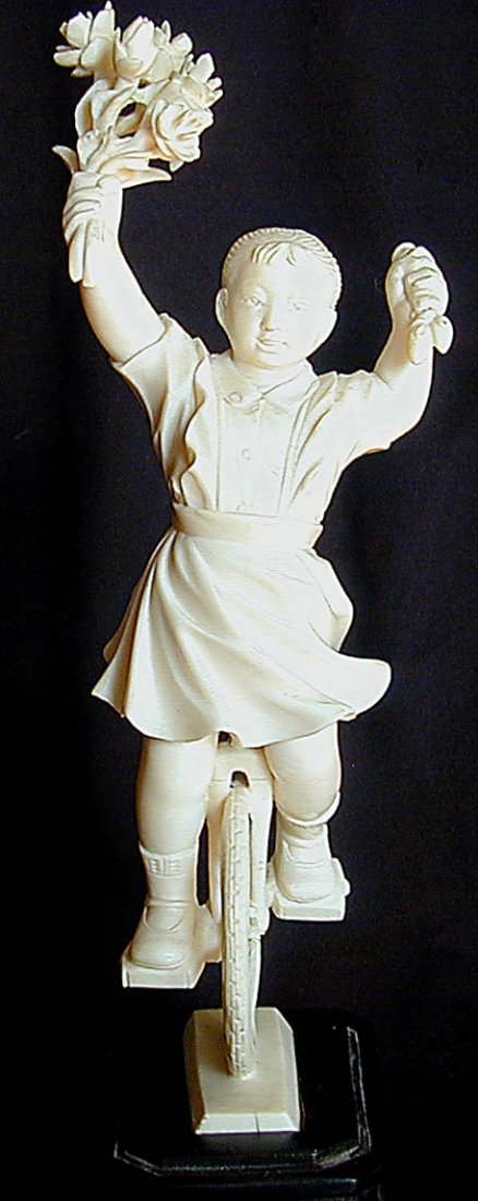 CHINESE CULTURAL REVOLUTION IVORY GIRL ON UNICYCLE A ra: CHINESE CULTURAL REVOLUTION IVORY GIRL ON UNICYCLE A rare and unusual ivory carving from the Chinese Cultural Revolution period depicting a young girl happily riding a unicycle, signed on the wood bas