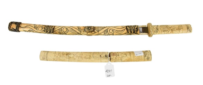 Two carved bone daggers smaller one has no blade just the sheath 13 inches long large larger one is