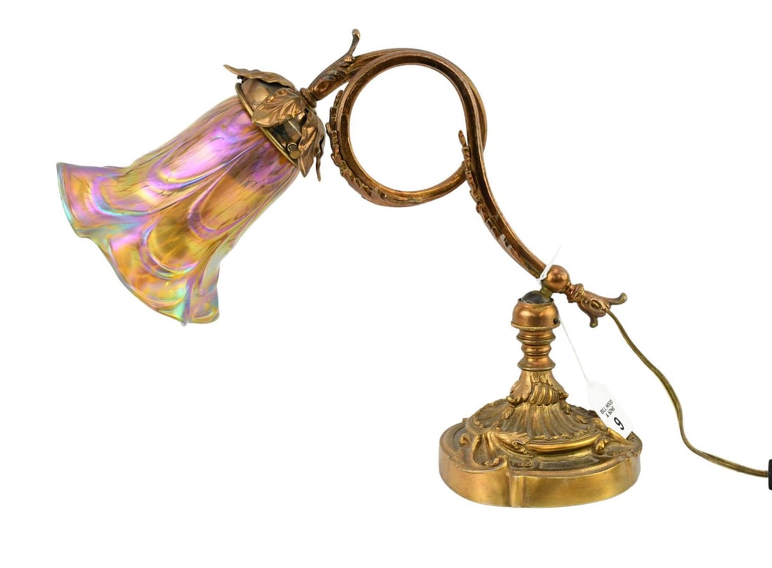 Art Nouveau Desk Lamp with Iridescent Glass Lily Shade - An Art Nouveau desk lamp with a gilt bronze: Art Nouveau Desk Lamp with Iridescent Glass Lily Shade - An Art Nouveau desk lamp with a gilt bronze base with acanthus scrolling motif, copper-tone patinated scrolling adjustable arm, with a Loetz st