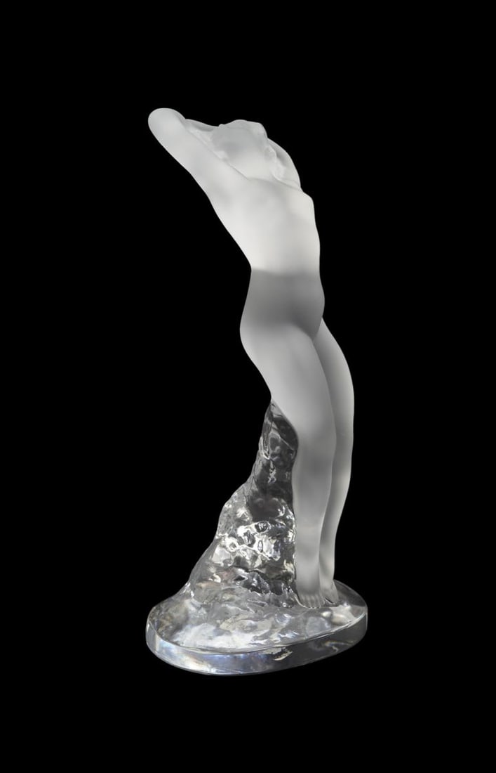Lalique Nude Dancer Crystal Figurine - France, 20th century. 'Danseuse bras leves'. Clear frosted: Lalique Nude Dancer Crystal Figurine - France, 20th century. 'Danseuse bras leves'. Clear frosted and polished crystal depicting a female nude dancer. Signed on edge of base. 9 1/4" h. Condition: Very