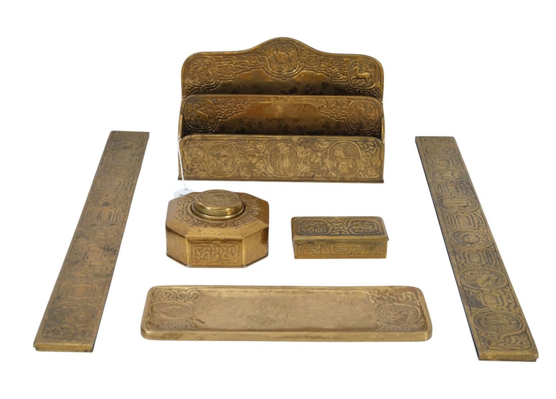 Tiffany Studios Zodiac Bronze Desk Set Accessories - C. Early 20th century. A six piece gilt bronze: Tiffany Studios Zodiac Bronze Desk Set Accessories - C. Early 20th century. A six piece gilt bronze desk set by Tiffany Studios in the Zodiac pattern, gold finish. Each piece signed "TIFFANY STUDIOS N