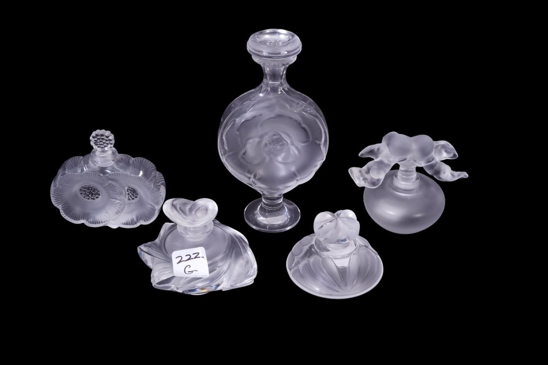 Group of 5 Lalique Perfumes Tallest 6.5" high x 3.5" wide x 1.5" deep One minor flea bite nick to: Group of 5 Lalique Perfumes Tallest 6.5" high x 3.5" wide x 1.5" deep One minor flea bite nick to one perfume otherwise all in good condition.