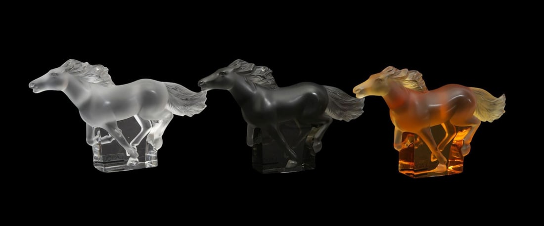 Trio of Lalique Crystal "Kazak" Horse Figurines - France, 20th century. Three (3) figurines of a: Trio of Lalique Crystal "Kazak" Horse Figurines - France, 20th century. Three (3) figurines of a running horse in clear, amber, and smoked crystal. Frosted and polished. All signed under tail and havi