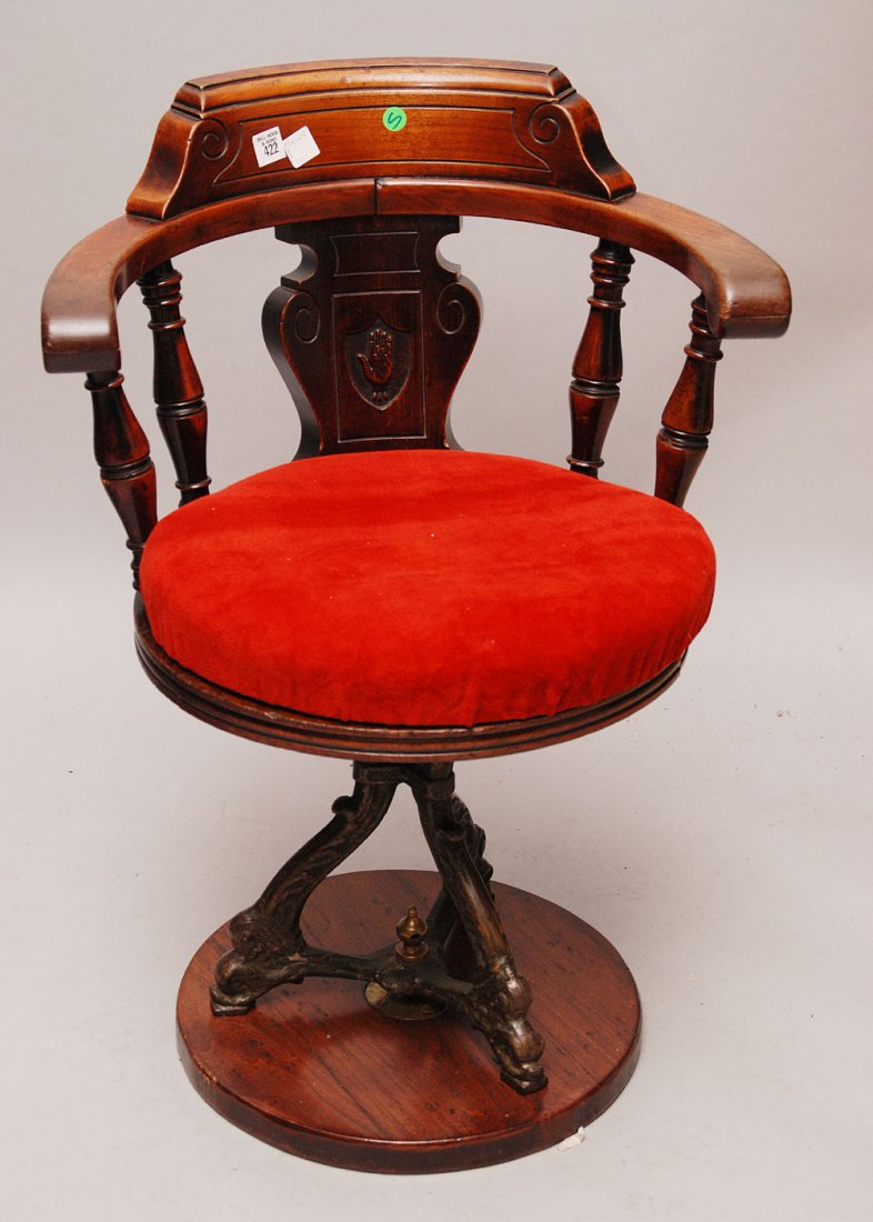 Unusual Victorian/Eastlake swivel arm chair on iron bas